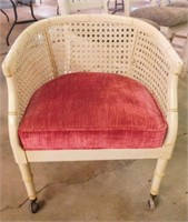 Cane & faux bamboo barrel back chair on casters,