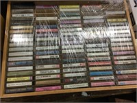 Large case of cassettes (covered in plastic wrap)