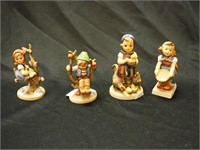 Four Hummel figurines ranging from