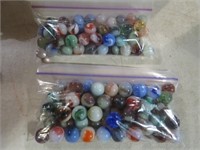 2 BAGS FULL OF MARBLES