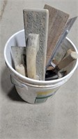 Bucket of concrete groover tools
