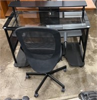 Nice black,  glass topped, desk with rolling