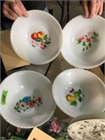 Four decorated plastic serving bowls