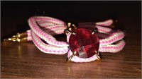 Adjustable woven pink bracelet with large pink