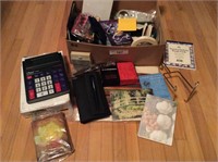 Box of office items magnifiers calculators day