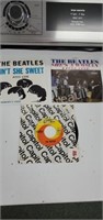 3 vintage Beatles 45 RPM vinyl records - ain't