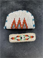 An intricately beaded coin purse with barrette in