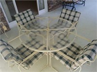 White wrought iron and glass top patio set