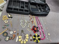 Costume jewelry pins. Necklaces with JM