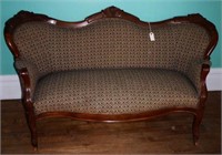 Victorian upholstered settee with carved back