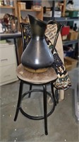 Chair, metal pitcher and two aprons
