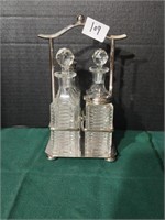 Antique 4-piece cruet set. Carrier is possibly