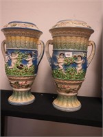 Pair of ceramic handled urns depicting cherubs,