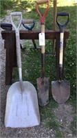 Assorted hand tools, shovels, rake, pitch fork