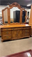 Dresser with attached folding mirror
