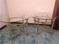Two yellow metal end tables with glass tops