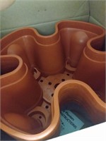 Box of large terracotta colored planters