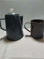 Vintage blue enamel teapot with cup.