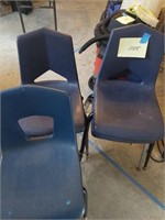 Five plastic stacking chairs