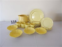 Yellow plates, bowls, cups and pitcher