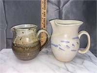 2 pottery pitchers