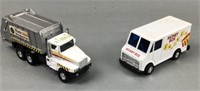 2 miniature toy trucks