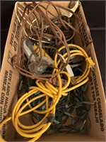 Box of assorted extension cords and Christmas