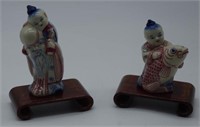 Two small Chinese figures on timber stands