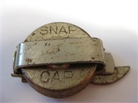 ANTIQUE FOLDING SNAP CAP AND OPENER