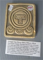 Vintage clay stone slab of Mayan wind god.