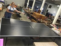 Folding ping pong table with paddles, balls, net.