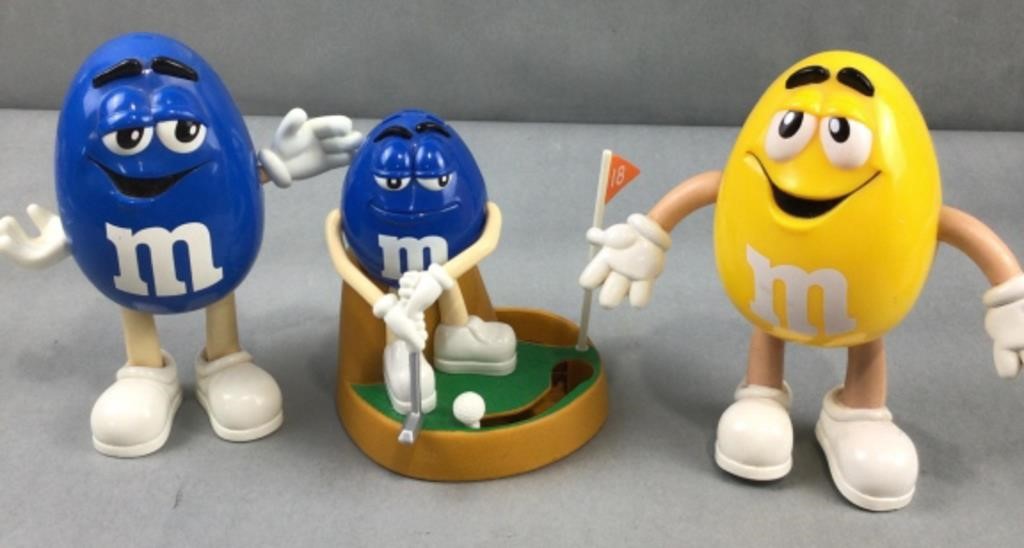 2 Blue M & M candy dispensers, and one yellow