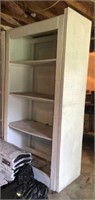 Wooden shelving unit with 3 sides of pegboard,