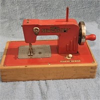 Vintage SEW MASTER toy sewing machine. Crack in