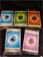 Five packs of Pokemon cards energy cards