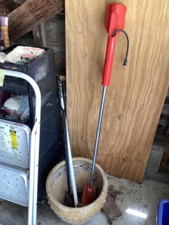 Fire tongs, electric weedeater, and planter