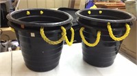 Black buckets with yellow handles