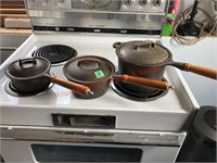 3 cast iron pots with lids
