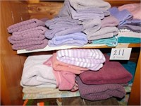 Two shelves of bath towels - wash cloths - hand