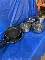 Several pots and a couple frying pans