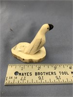 2 1/2" carved ivory bird mounted on a piece of fos