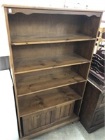 Pine bookcase with sliding bottom doors