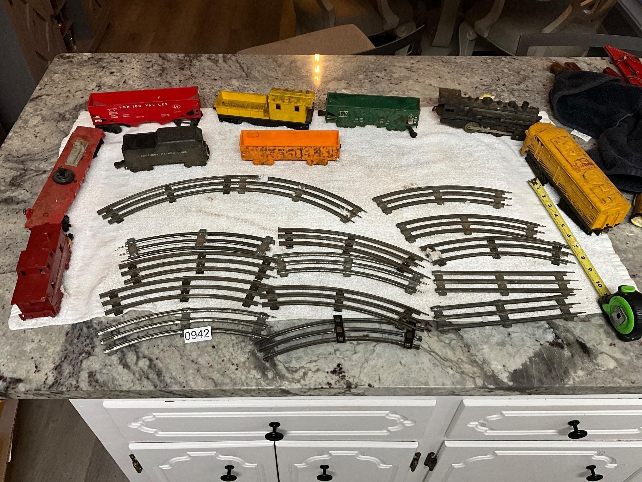 Train engines, cars, track- one made by Lionel