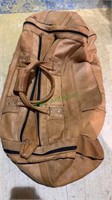 Brown leather duffel bag, with black zippers,