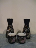 hand painted sake pitcher and glasses .