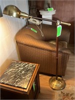 Brass floor lamp with swing arm.