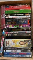 Box of DVDs and VHS tapes.  Includes Dark Night,