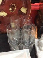 Four Pilsner glasses in carrying basket