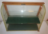 Countertop showcase with curved glass front,