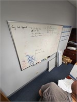 White dry erase board hanging on wall.